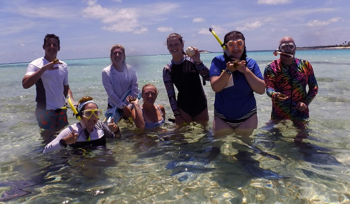 Students holding slimy sea hares